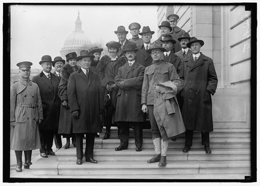 LINN, SGT. W.A. RIGHT FRONT; WITH REP. J. HAMPTON MOORE, CENTER; GEORGE O'CONNOR, LEFT CENTER FRONT; AND OTHERS ON STEPS OF H.O.B.
