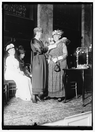 PALMER, MRS. A. MITCHELL. BEING DECORATED BY MRS. W.G. McADOO