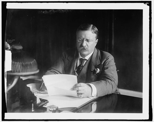 ROOSEVELT, THEODORE. AT DESK