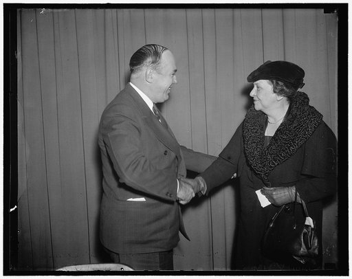 Berry and Perkins. Washington, D.C., Dec. 11. Maj. George L. Berry, President Roosevelt's Coordinator for Industrial Cooperation, greets Secretary of Labor Frances Perkins, as she arrives to address the conference of Industry and Labor today in Washington. In her address, Secretary Perkins appealed 