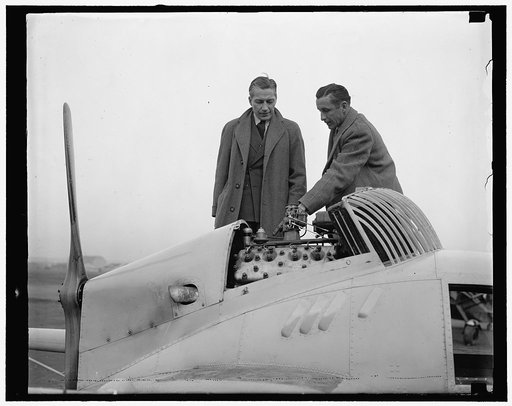 Vidal inspects engine in new Flivver plane. Washington, D.C., Dec. 15. A new Flivver plane, powered with a Ford V-8 Motor and capable of a cruising speed of 95 miles an hour, was demonstrated to Eugene Vidal, Director of the Bureau of Air Commerce, Department of Commerce, today. The plane has a wing