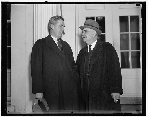 Tugwell's successor at White House with boss. Washington, D.C., Dec. 22. Secretary of Agriculture Henry a Wallace, (left) and Dr. W. Alexander, successor to Rex Tugwell as Resettlement Administrator leaving the White House following a conference with the President Roosevelt. Wallace told newpapermen
