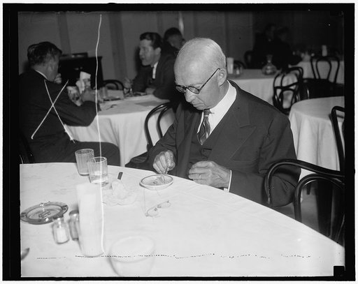 Vermont Senator, an ice cream fiend. Washington, D.C., Dec. 23. Senator Ernest W. Bigson, Republican of Vermont, tops off his luncheon with a plate of ice cream. It's his favorite sweet