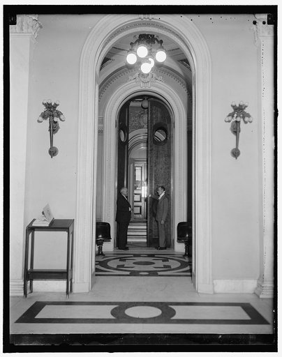 House doors conditioned for Opening. Washington, D.C., Dec. 30. The huge doors through which the lawmakers of the lower house of Congress will pass for the 75th session were opened and tested today by doorkeeper Joseph J. Sinnott (right), assisted by Rep. Harold Knutson, of Minnesota