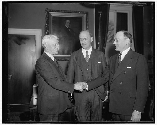 United States Secret Service gets new chief. Washington, D.C., Dec. 31. William H. Moran, retiring Chief of the United States Secret Service, congratulates his successor Frank J. Wilson, whose appointment was announced today at the Treasury. Morgenthau is in the center. Moran has spent 54 years in t