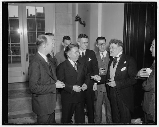 Senate 'Beau Brummel' meets gentlemen of the press. Washington, D.C., Jan. 6. Senator J. Ham Lewis, Democrat of Illinois and the Beau Brummel of the Senate, is always a good source for the news for the boys who cover Capitol Hill. The Senator is shown here with the newsmen as he was on his way to th