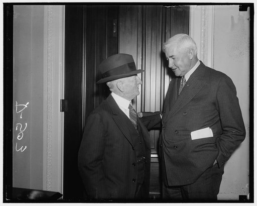 Money experts. Washington, D.C., Jan. 7. Senator Carter Glass, former Secretary of the Treasury and an expert on monetary matters, pictured with Jesse Jones, Chairman of the R.F.C., as both attended the conference today between leaders of the administration and the Senate and House to discuss legisl
