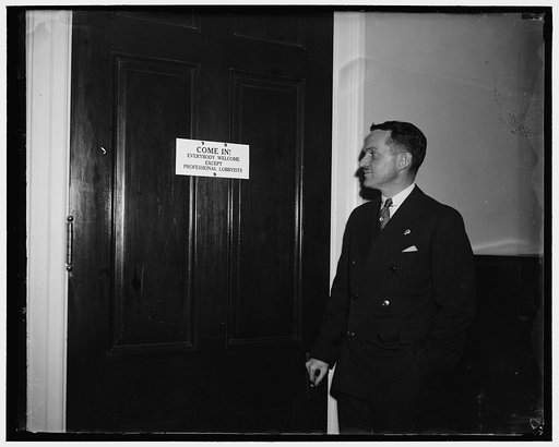 Lobbyists taboo at Capitol. Washington, D.C., Jan. 8. Rep. Alfred M. Phillips Dem. of Stanford, Conn. looks over the sign that hangs on his office door, saying that as yet no lobbyists has passed his portals. He would recognize a lobbyist by his talk the Congressman states