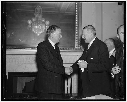 Whitney returns to testify. Washington, D.C. Jan. 15. Sen. Burton Wheeler (left) greets Richard Whitney as the former President of the New York Stock Exchange returns to testify before the Railroad Committee at the Senate today