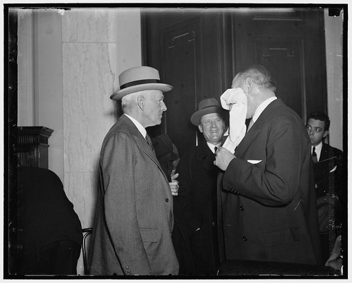 "Whew" thatÆs that. Washington, D.C. Jan. 15. Richard Whitney is moping the brow after the heated tussel with Sen. Wheeler today when the Senator implied that Whitney as an Officer of the Stock Exchange bought 1,000 shares of Alleghany at $20 when the market price was $33. Photo shows left to right: