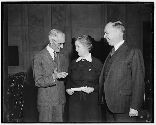 Dr. Townsend and Representatives. Washington, D.C. Jan. 16. Photo shows Dr. Townsend explaining the new 'General Welfare Bill' which is that name the doctor is trying to have made a law thru the efforts of some of his Congressmen. Left to right: Dr. Francis E. Townsend, Rep. Nan Honeyman of Oregon, 