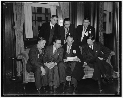 Striking Seamen see Secretary Roper. Washington, D.C. Jan. 18. A committee of striking seamen from Baltimore, Philadelphia, New York and Boston, called on Secretary of Commerce Roper today to protest against provisions of the Copeland Saftey-At-Sea Act. In the photograph, left to right, seated: Patr