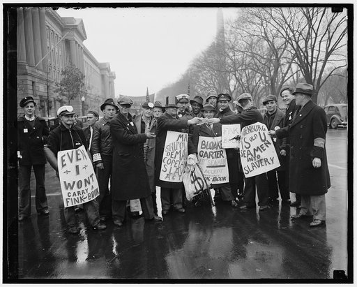 Striking Seamen picket Commerce Department. Washington, D.C. Jan. 18. A cold drenching rain failed to dampen the spirit of nearly 500 east coast seamen from Baltimore, Philadelphia, New York and Boston, as they picketed the Commerce Department today as a protest against provisions of the Copeland Sa