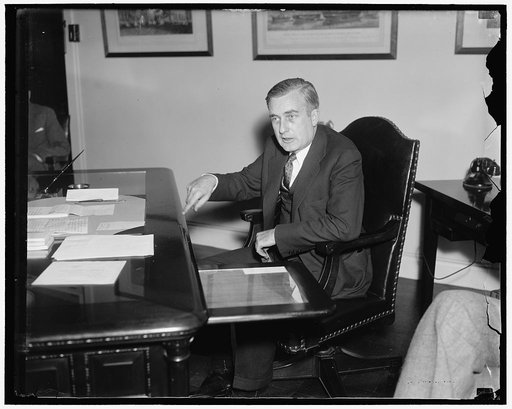 On job. Washington, D.C. Jan. 19. Charles Edison, son of the famous inventor and new Assistant Secretary of the Navy, pictured at his desk today. He was inducted into office yesterday