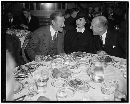 At housing luncheon. Washington, D.C. Jan. 19. Stuart Macdonald, (left) Federal Housing Administrator, with Governor and Mrs. Lloyd Stark of Missouri, pictured at the housing luncheon for state Governors attending the Inauguration