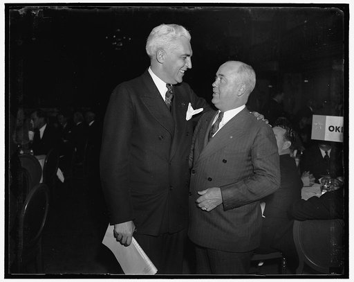 Oklahoma and Indiana bosses meet at Governors' luncheon. Washington, D.C. Governor James Berry of Oklahoma, (left) and Paul V. McNutt, former Governor of Indiana, meet at the housing luncheon given for state Governors today at the Mayflower Hotel