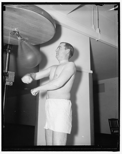 Rep. Albert Thomas of Tex. punching the bag at the House gym