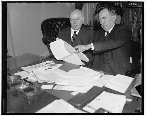 House leaders study president's message. Washington D.C. President Roosevelt's sensational message to Congress today, demanding overhauling of the Judiciary, struck Congressional leaders like a bolt from a clear sky. Copies of the speech were at a premium on Capitol Hill. Here we see Rep. Hatton W. 