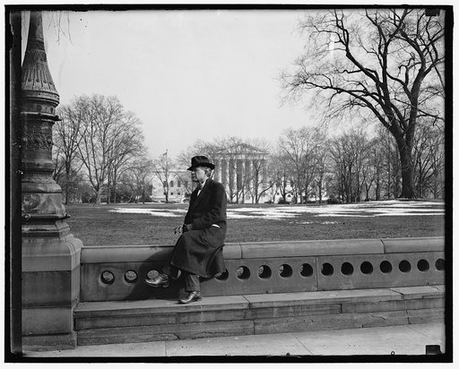 Idaho Senator ponders. Washington D.C. The cameraman catches Senator William E. Borah, veteran Idaho legislator, as he rests after a stroll though the Capitol grounds today. With the Supreme Court in the background Senator Borah picked a good spot to ponder the President's latest message to Congress