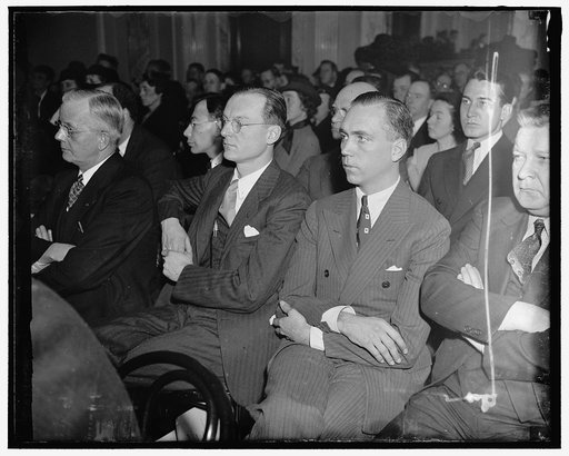 In spotlight at Labor Espionage Investigation. Washington D.C. E.C. Davidson (left), Secretary of the International Association of Machinists and Mayor of Alexandria, Va., who told the Senate Civil Liberties Committee today that the Pinkerton Detective Agency sought to sell it's service to the Commi