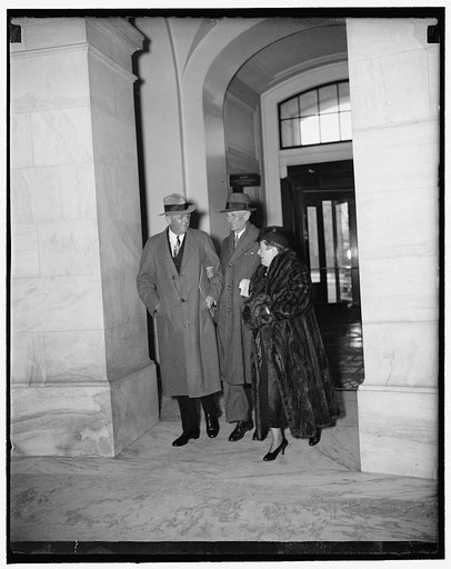 Attorney General arrives for Senate Judiciary Committee hearing. Washington, D.C., March 10. Attorney General Homer S. Cummings with Mrs. Cummings arriving at the Capitol today where the Attorney General appeared as the first witness before the Senate Judiciary Committee on the President's plan for 