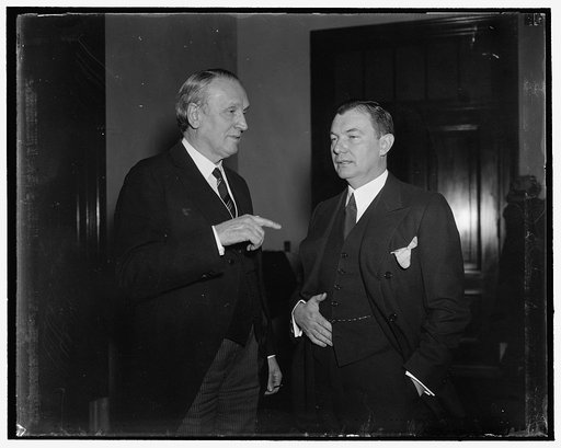 Judiciary Hearing. Washington, D.C., March 11. Senator Henry F. Ashurst, D. of Arizona, Chairman of the Senate Judiciary Committee left: shown with the Assistant Attorney General Robert Jackson, who testified that "it is idle to contend, that is was ever intended that the Supreme Court become a supe