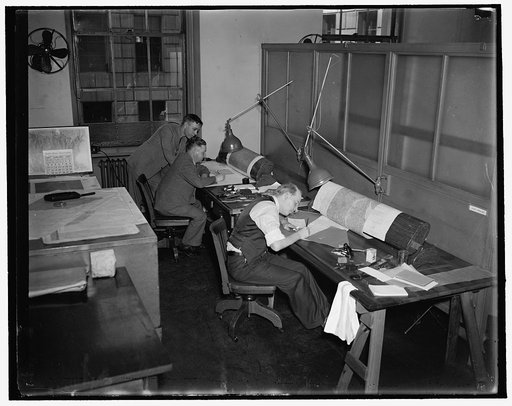 Left to right: Lt. C.M. Durgin, Chief of Aeronautical Chart Section; John J. Braund; Raymond K. Peck, compiling and drafting aeronautical charts