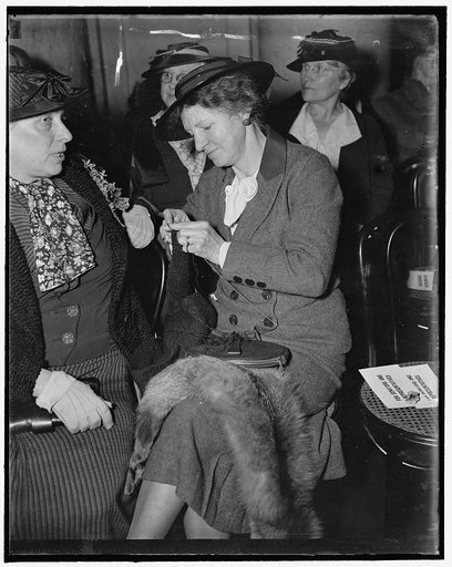 Knits while husband burns. Washington, D.C., Mar. 22. Mrs. Burton K. Wheeler, wife of Senator Wheeler of Montana calmly knits while her husband is burning up at the cross examination of his fellow senators as he took the stand today before the Senate Judiciary Committee. The senator is opposed packi