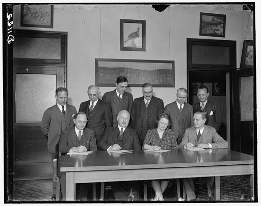 Hatchery Tribune. Standing, left to right: H.W. Marston, Office of Experiment Station; Dr. J.W.T. Duval, Commodity Exchange Adm.; E.G. Moore; Dr. H.C. McPhee; Roy C. Potts and Dr. Moskey. Seated, left to right: Mr. Beverly Winton, Bureau of Animal Industry; Dr. J.R. Mohler, Chief of Bu. of Animal In