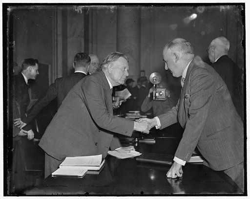 Borah greets Moley. Washington, D.C., March 23. Senator William E. Borah, Republican from Idaho, greets Raymond Moley, former ace member of the Roosevelt "brain trust" as he arrived to express his opposition to the president's court reform plan before the Senate Judiciary Committee, 3/23/1937