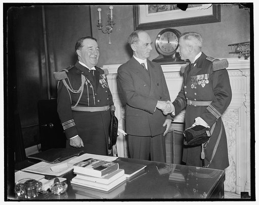 U.S. Chief of Naval Operations greets Skipper of visiting French Cruiser. Washington, D.C., March 24. Capt. H.P. Latham, Skipper of the French Cruiser Jean D'Arc no visiting American ports, was received by admiral William Leahy, (center) Chief of Naval Operations today. On the left is Capt. Louis Sa