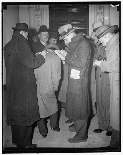 Newsmen get dope from Senate majority after White House discussion in sit-strikes. Washington, D.C., March 27. Majority leader of the Senate, Senator Joseph T. Robinson discusses possible congressional action on the sit-down strike crisis with reporters following a White House conference today. Afte