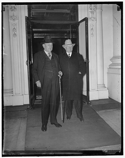 Senate leaders leave White House conference on sit-down stike crisis. Washington, D.C., March 27. Senate majority leader Joseph T. Robinson, (left) and Vice President Garner as they left a White House conference today with President Roosevelt on the sit-down strike situation. Senator Robinson announ