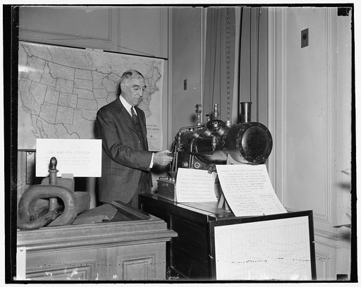 50 years for the I.C.C. Washington, D.C., April 7. Carroll Miller, Chairman of the Interstate Commerce Commission, is shown looking over the model of the first boiler ever made by one of the men of the Commission back in 1911. This is one of the safety appliances with glass windows and gauges so tha