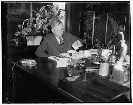 Secretary of Interior enjoys lunch in new office. Washington, D.C., April 6. Secretary of Interior Harold Ickes enjoying his first lunch prepared in the fully equipped kitchen which is a feature in his office in the newly completed $13,000,000 Interior building, 4/6/1937