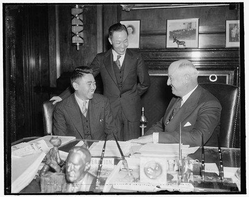 PMG Farley receives official of China Post Office Confederation. Washington, D.C., April 14. PMG Farley probably was telling on of his stock campaign jokes to Chi Hsueh Fan, official of the National Post Office Confederation of China, as this picture was made. Farley received the official today with