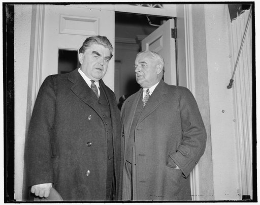 At White House. Washington, D.C., April 14. John L. Lewis, President of the United Mine Workers, and Senator Joseph Guffey, both ardent supporters of the Guffey-Vinson Coal Control Bill of which Guffey is the author, leaving the White House today after a conference with President Roosevelt. The meas