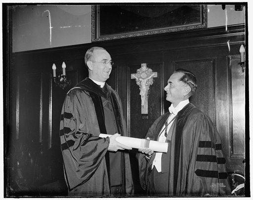 Georgetown University confers honorary degree on president of Philippines. Washington, D.C., April 19. President Manuel Quezon of the Philippines receiving the honorary degree of Doctor of Laws from Georgetown University with the very Reverend Arthur O'Leary, President of the School, conferring the 