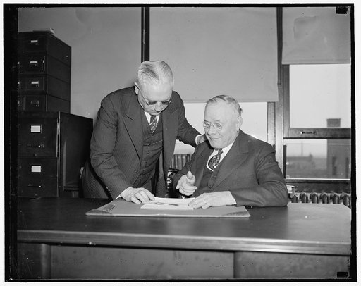 At A.F. of L. meeting. Washington, D.C., April 19. William Green, President of the American Federation of Labor, and Daniel J. Tobin, (standing) Vice President, held a last minute confab today before attending a meeting of the Executive Council of the Federation to consider calling an emergency conv