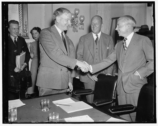 Sen. Wheeler greets new RR empire owners. Washington, D.C., May 6. Senator Burton K. Wheeler of Mont. Chairman of the Railway Finance Committee of the Senate is shown greeting the new owners of the Van Sweringen Railroad Empire before the hearing started today at the above Committee. Left to right: 