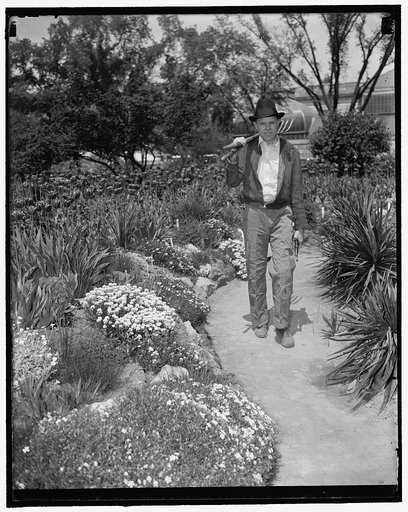 All finished with the work. Washington, D.C., May 7. Rep. W.R. Poage of Texas, is shown with his tools over his shoulder after working in the Botanical Gardens at the capital. (see other caption for full story) no. 5
