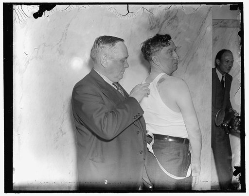 Union Representative displays bullet wound received from Harlan County sheriffs. Washington, D.C., April 27. A.T. Pace, Representative of the United Mine Workers, inspects the bullet wound in the back of Thomas Ferguson, Coal Miner Representative, who testified before the Senate Civil Liberties Comm