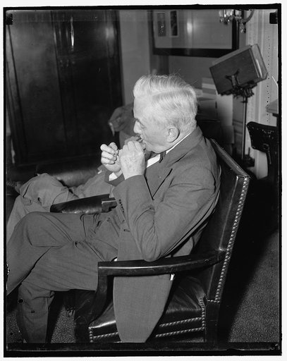 Veteran Nebraska Senator. Washington, D.C., May 15. Senator George W. Norris, Independent-Republican from Nebraska, lights a stogie while attending the Senate Judiciary hearing the other day, 5/15/1937