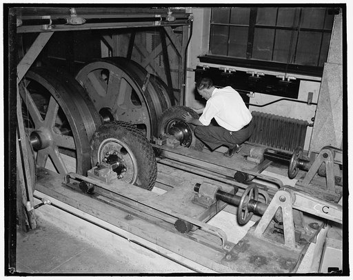 Tire testing machine. Washington, D.C., May 20. Testing wear and tear on tires with this tire testing machine at the Bureau of Standards is W.D. [?] hold, the machine simulates road tests traveling from 20 to 60 mph, the only difference is that the load on the tires is heavier than the normal weight