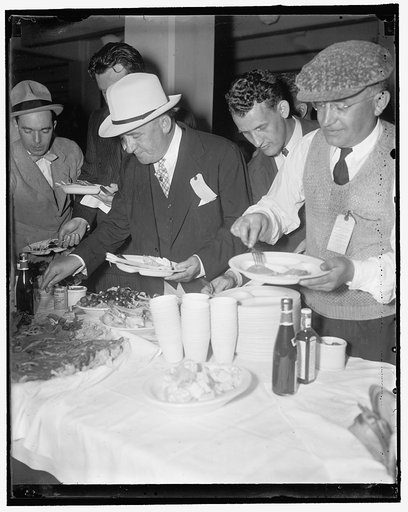 Lunch on the run. Quantico, Va., 5/22/37. Knowing the [...]city of hungry newsmen, Rep. John J. O'Connor, Democrat of New York, was among the first to get his buffet lunch at the annual picnic of the National Press Club, 5/22/1937