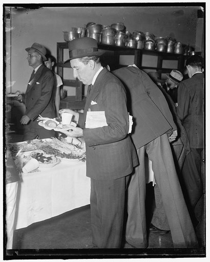Chow time for Florida Senator. Quantico, Va., May 22. Democratic Senator from Florida Claude A. Pepper helps himself to a bit of chow as he attends the annual picnic of the National Press Club