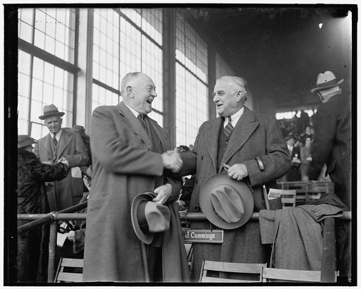Senator Joseph F. Guffey, of Penna., right with CY Cummings, a member of the Curtis Walker Democratic Club, and well known in Maryland's racing circles, snap as they greated each other at the Bowie meet