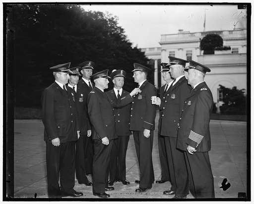 White House cops win medals in pistol shoot. Washington, D.C. June 10. In the International Police Pistol shoot held at Philadelphia, P.A. June 5th the team from the White House Police Force placed 11th out of 75 teams. Photo shows Capt. C.L. Dalrymple presenting John J. Cash with his medal. Cash sc