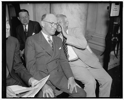 Last minute advice. Washington, D.C., June 24. Tom Girdler, (left) Board Chairman of the Republic Steel Corporation, gets last minute instructions from his Chief Second, Donald B. Gillis, Vice President of the Republic Corp., before he (Girdler) took the stand today at the Senate Post Office Committ