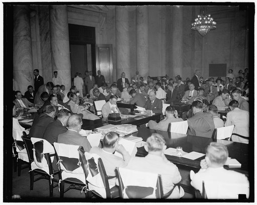 Girdler takes oath. Washington, D.C., June 24. Tom Girdler, Board Chairman of the Republic Steel Corporation, being sworn in as he took the stand today before the Senate Post Office Committee to describe his company's troubles with John L. Lewis: C.I.O., 6/24/37. General view of hearing